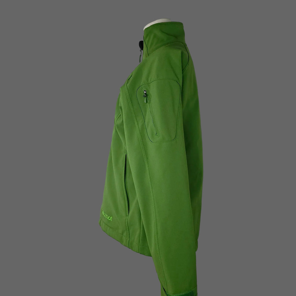 A bright green softshell jacket displayed on a mannequin torso against a white studio backdrop. The jacket features a high collar, a zippered chest pocket, and a small green logo near the lower hem.